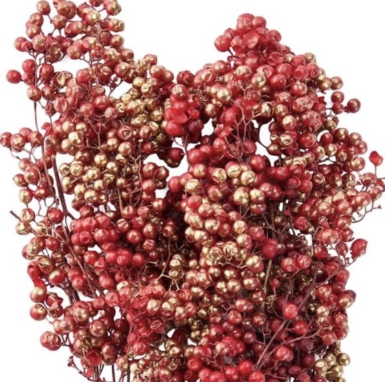 A close-up image of vibrant red pepper berries clustered together, some shimmering with a shiny golden hue. The dense, decorative arrangement resembles a festive pumpkin with flowers, highlighting the striking contrast between the red and gold colors.